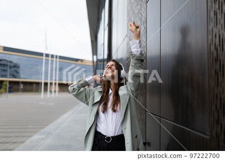 young woman in headphones dancing in the city young woman in headphones dancing in the city 97222700