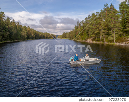 aerial footage couple Kayaking Boat tour on lake Ragnerudssjoen in Dalsland Sweden beautiful nature forest pinetree aerial footage couple Kayaking Boat tour on lake Ragnerudssjoen in Dalsland Sweden beautiful nature forest pinetree 97222978