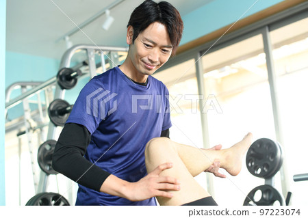 Male physiotherapist doing sports manipulative massage 97223074