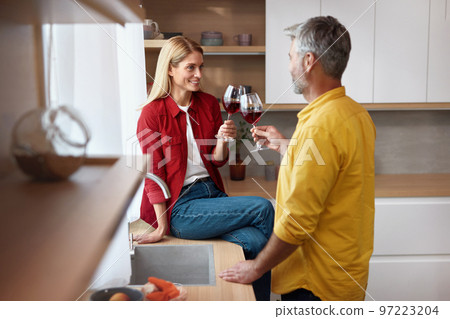Happy Couple Drinking Wine. Smiling Senior Spouses Holding Wineglasses 97223204