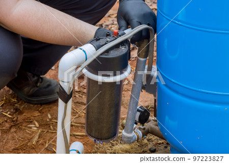 In order to maintain clean water in outside near house, professional workers replace replaceable filters on regular basis 97223827