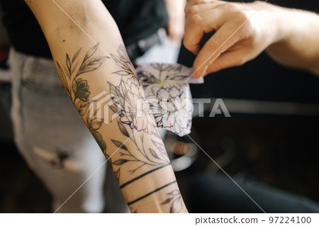 Man applying a tattoo stencil on woman hand  Stock Photo 97224100   PIXTA