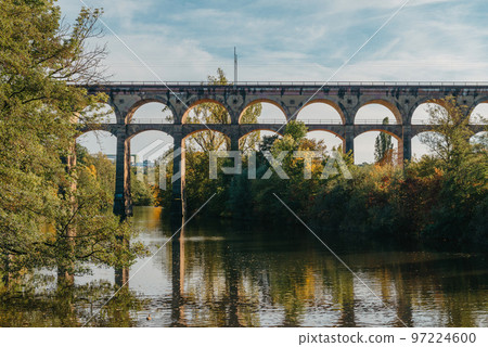 Railway Bridge with river in Bietigheim-Bissingen, Germany. Autumn. Railway viaduct over the Enz River, built in 1853 by Karl von Etzel on a sunny summer day. Bietigheim-Bissingen, Germany. Old 97224600