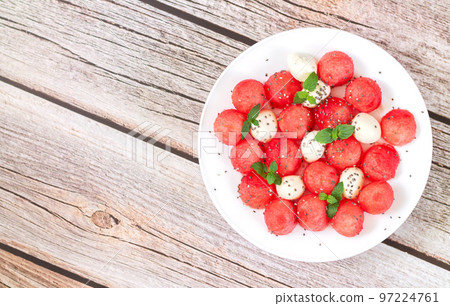 Summer fruit salad with watermelon, mozzarella cheese top view 97224761