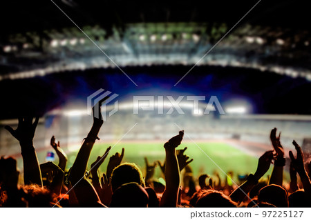 football or soccer fans at a game in a stadium world cup 97225127