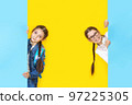Girls sisters holding blue empy poster and smiling. Copyspace 97225305
