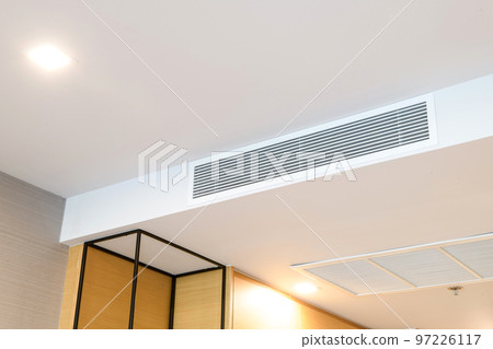 Ceiling mounted cassette type air conditioner and modern lamp light on white ceiling. duct air conditioner for home or office 97226117