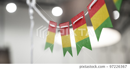 A garland of Guinea national flags on an abstract blurred background A garland of Guinea national flags on an abstract blurred background 97226367