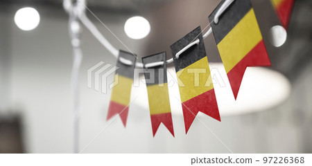 A garland of Belgium national flags on an abstract blurred background 97226368
