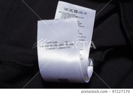 100 cotton tag in various languages on black jumper 100 cotton tag in various languages on black jumper 97227170