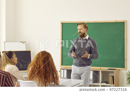 Portrait of happy male professor during class with chalk board on background. Portrait of happy male professor during class with chalk board on background. 97227316
