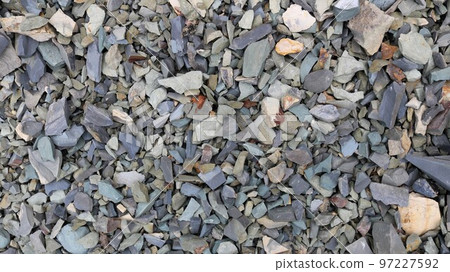 sharp crunchy stones as a textured surface, broken stones of different shades of gray and beige as a natural background full frame, fine gravel as a material for construction work 97227592