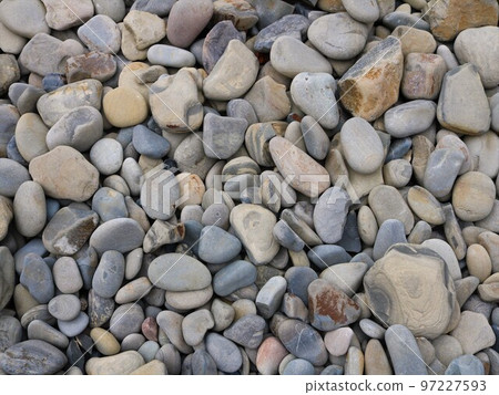 stone background of round cobblestones of different shades of gray and brown, natural texture of rounded river or sea stones full frame, stones and minerals on the coast of the sea or river 97227593
