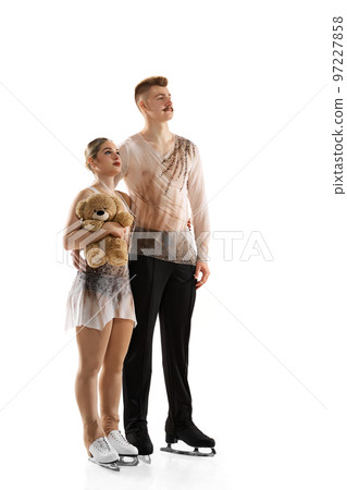 Winners. Portrait of young man and woman, figure skating athletes posing isolated over white studio background Winners. Portrait of young man and woman, figure skating athletes posing isolated over white studio background 97227858