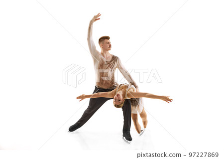 Portrait of young man and woman, figure skating athletes performing isolated over white studio background Portrait of young man and woman, figure skating athletes performing isolated over white studio background 97227869