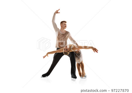 Attraction. Portrait of young man and woman, figure skating athletes performing isolated over white studio background Attraction. Portrait of young man and woman, figure skating athletes performing isolated over white studio background 97227870