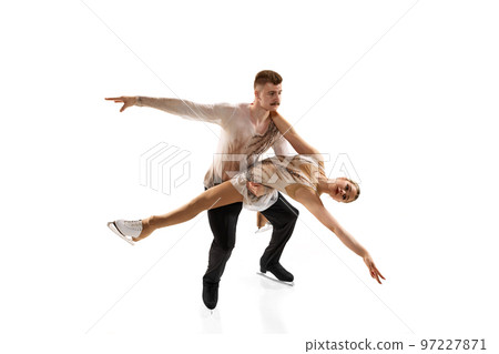 Young man and woman, figure skating athletes performing, dancing isolated over white studio background Young man and woman, figure skating athletes performing, dancing isolated over white studio background 97227871