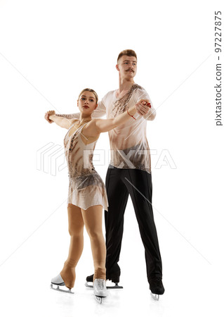 Portrait of young man and woman, figure skating athletes in beautiful stage costumes posing isolated over white studio background Portrait of young man and woman, figure skating athletes in beautiful stage costumes posing isolated over white studio background 97227875