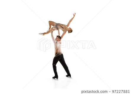 High flight. Portrait of young man and woman, figure skating athletes performing isolated over white studio background High flight. Portrait of young man and woman, figure skating athletes performing isolated over white studio background 97227881