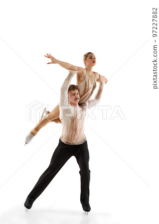 Shoulders support. Portrait of young man and woman, figure skating athletes performing isolated over white studio background Shoulders support. Portrait of young man and woman, figure skating athletes performing isolated over white studio background 97227882