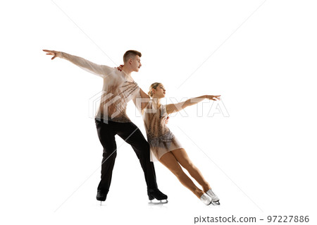 Portrait of young man and woman, figure skating athletes performing isolated over white studio background Portrait of young man and woman, figure skating athletes performing isolated over white studio background 97227886