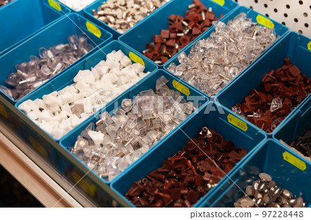 Boxes with furniture accessories in a hardware store 97228448