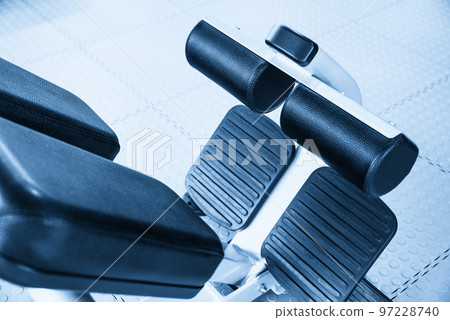 Abdominal machine inside a gym, fitness concept Abdominal machine inside a gym, fitness concept 97228740