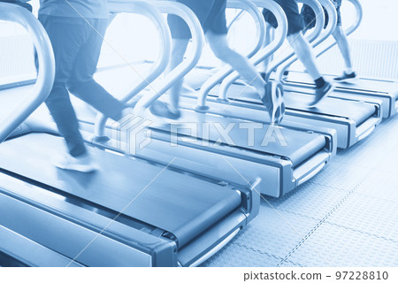 Sportsmen using jogging track for heath in gym with motion blur 97228810
