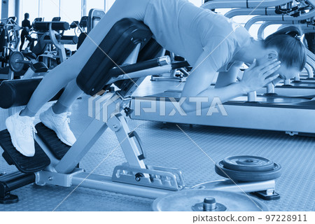 Young sporty woman workout on exercises machine in gym 97228911