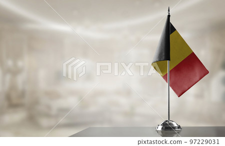 A small Belgium flag on an abstract blurry background 97229031