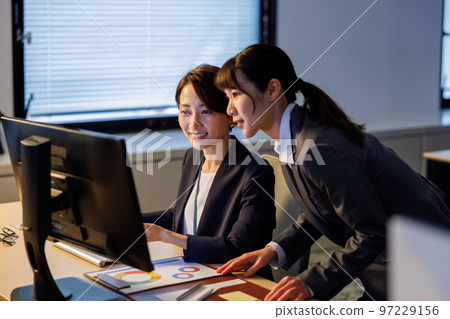 Business woman staying in the company and working late 97229156