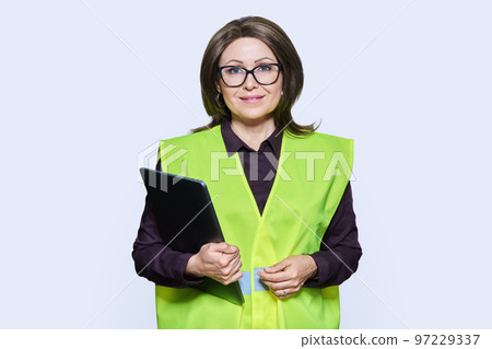 Portrait of engineer manager woman in vest holding laptop Portrait of engineer manager woman in vest holding laptop 97229337