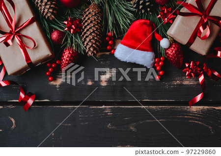 Christmass background gift boxes,red christmas tree toys,Santa hat and spruce brance on wooden background. Christmass background gift boxes,red christmas tree toys,Santa hat and spruce brance on wooden background. 97229860