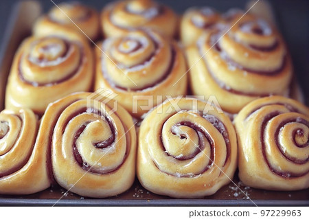Beautiful lush cinnamon buns with fruit filling Beautiful lush cinnamon buns with fruit filling 97229963
