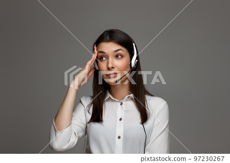 friendly smiling woman with headset is consulting clients online. 97230267