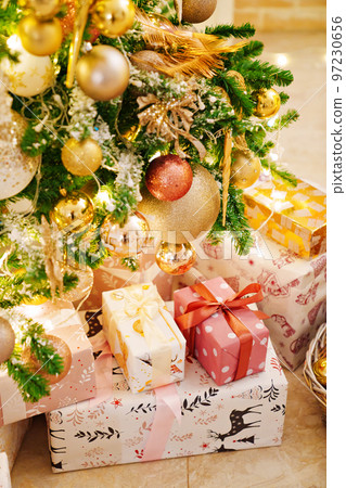 boxes with gifts on the Christmas tree with classic decorations. 97230656