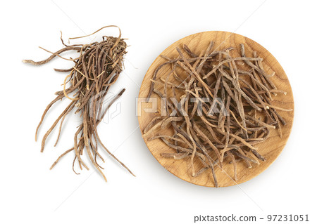 Dried Valerian root in wooden bowl isolated on white background. Valeriana officinalis with full depth of field. Top view. Flat lay 97231051