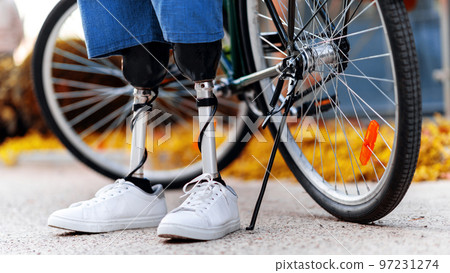 View of a man with prosthetic legs and white sneakers 97231274