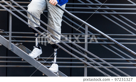 View of a walking man with prosthetic legs 97231327