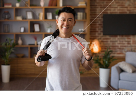 Active sporty lifestyle. Excited japanese middle aged man holding trx resistance bands hang around his neck 97233090