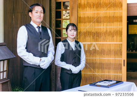 Funeral, farewell ceremony, ceremony staff greeting at the reception of the wake, funeral directors, men and women of the funeral home 97233506