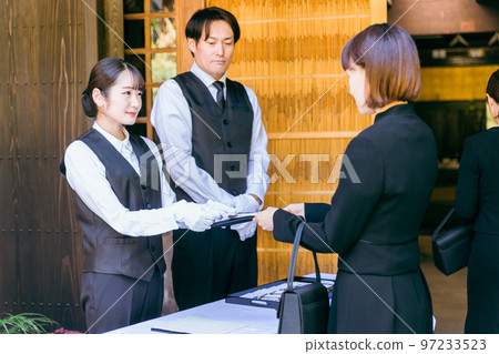 Ceremony staff and funeral director men and women who receive condolences at the reception of funerals, farewell ceremonies, and wakes Ceremony staff and funeral director men and women who receive condolences at the reception of funerals, farewell ceremonies, and wakes 97233523