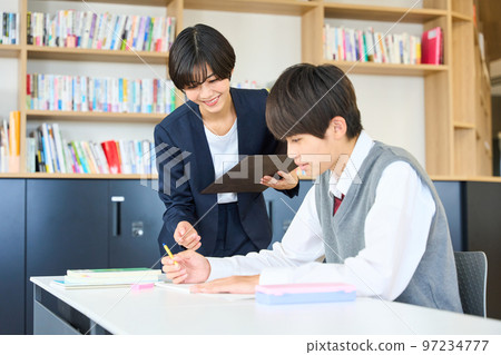 Junior high school students studying, teachers giving guidance, high school entrance exams 97234777