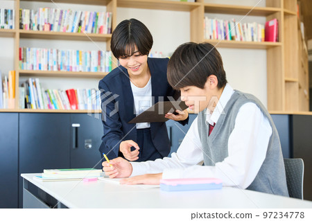 Junior high school students studying, teachers giving guidance, high school entrance exams 97234778