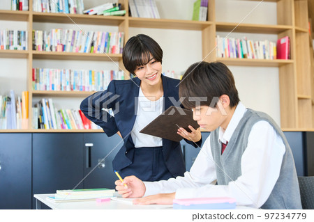 Junior high school students studying, teachers giving guidance, high school entrance exams 97234779