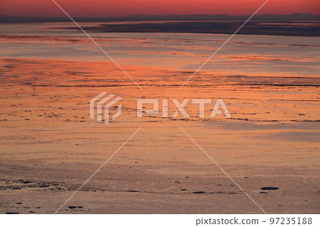 Okhotsk Sea ice current dyed in the setting sun 97235188