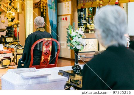 Back view of a Buddhist monk who recites sutras at a temple 97235236