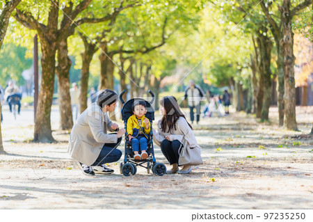 A family walking on a sidewalk 97235250