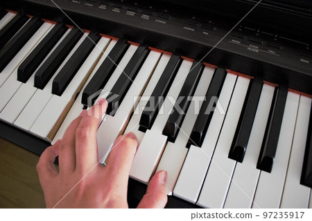 Fingers playing the piano Female hands 97235917
