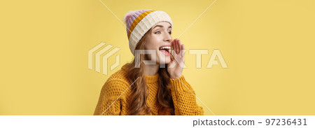 Attractive happy girlfriend shout call boyfriend standing far away take pic, turning left scream hold hand near opened mouth seek friend yelling loudly, search someone, yellow background Attractive happy girlfriend shout call boyfriend standing far away take pic, turning left scream hold hand near opened mouth seek friend yelling loudly, search someone, yellow background 97236431